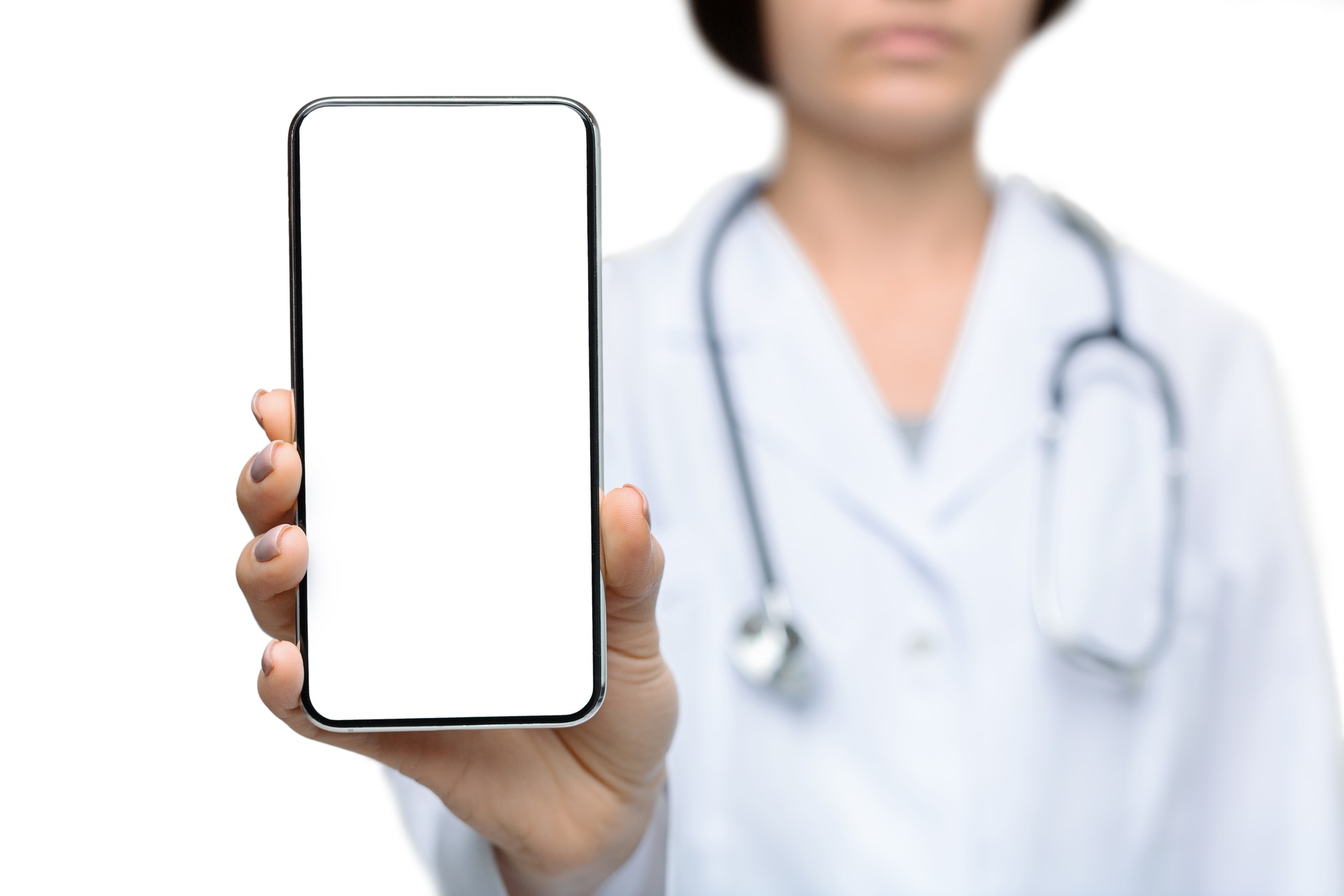 Female doctor holding smartphone with a blank screen for advertisement